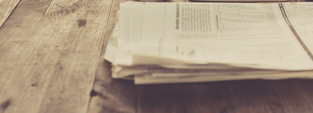 newspaper pages on wooden table