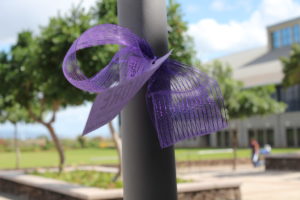 pole with purple ribbon tied around it