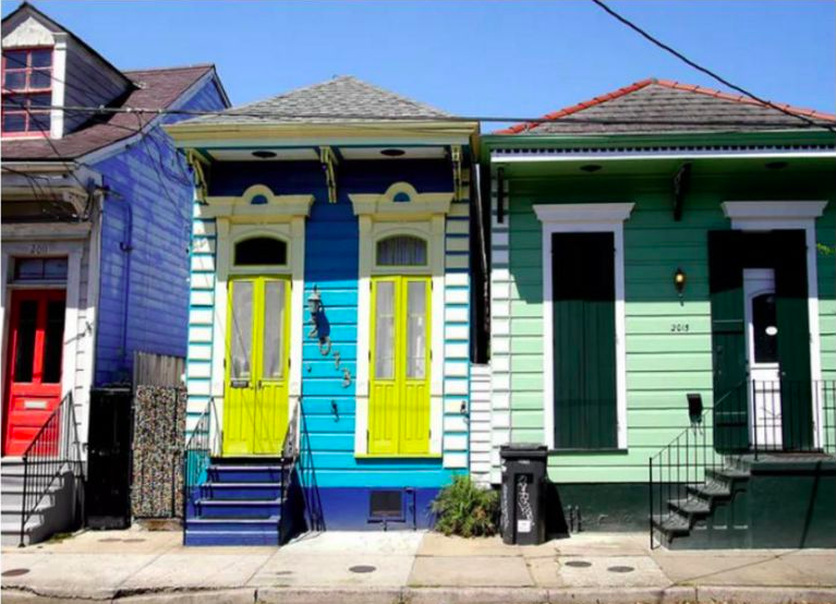 two brightly multi-colored shotgun houses