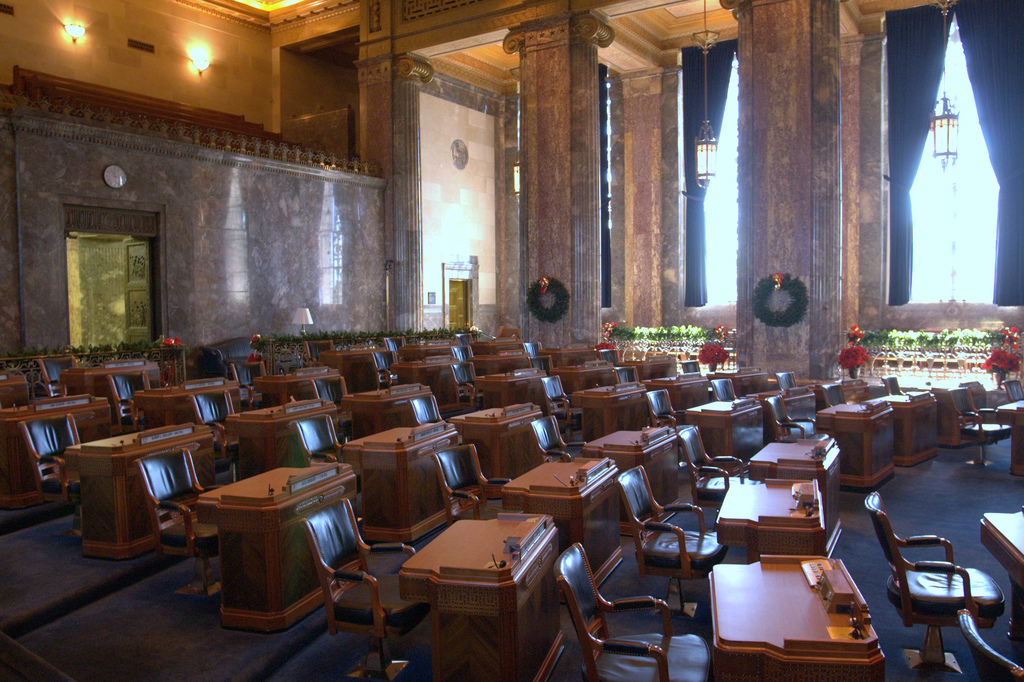 State Senate Chambers, dark room with many small desks and a couple large windows - Louisiana State Capitol - Baton Rouge