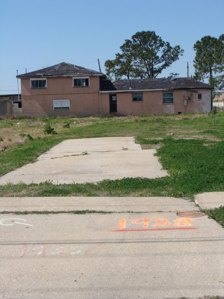 brown house and yard in the lower 9th ward on Flood Street