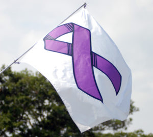 white flag with purple ribbon on it