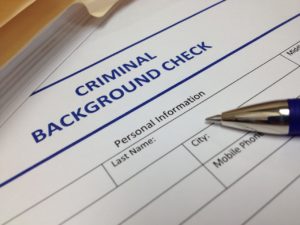 "criminal background check" paperwork and pen