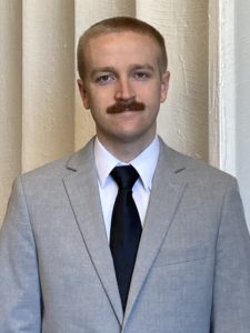 portrait of dylan perry in gray suit and tie