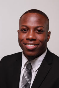 portrait of jaylen thomas in black suit and tie