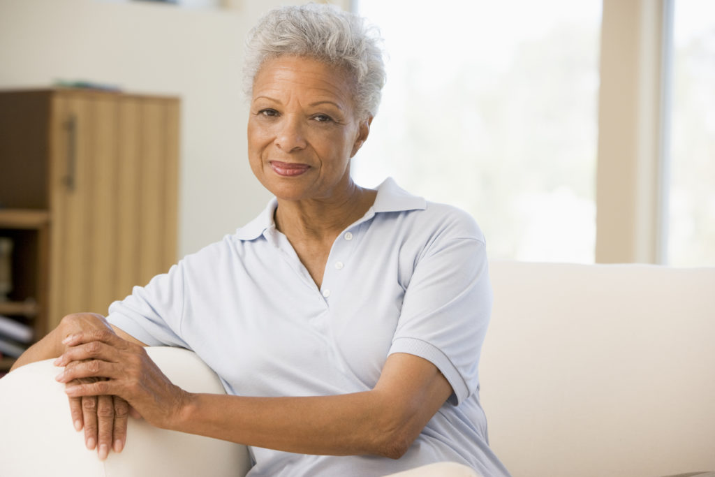 Older African American woman sitting on couch